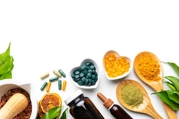 istock Nutritional supplements on white background. Lower border with copy space. Natural vitamins or healthy eating and dieting. Healthcare or alternative medicine 2230299340
