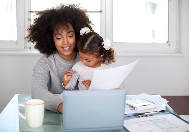 istock Young mother working and spending time with her daughter 2230300041