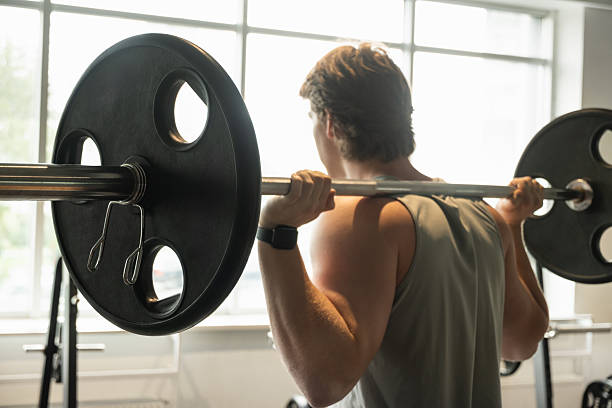 istock Cross training. Male athlete lifting weights. Workout Session 2230300091