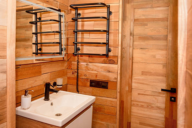 istock A compact and stylish bathroom featuring wooden panel walls, a modern sink design, and essential fixtures. Natural aesthetics with a contemporary touch, ideal for interior design inspiration. 2230301701