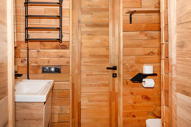 istock A compact and stylish bathroom featuring wooden panel walls, a modern sink design, and essential fixtures. Natural aesthetics with a contemporary touch, ideal for interior design inspiration. 2230301704
