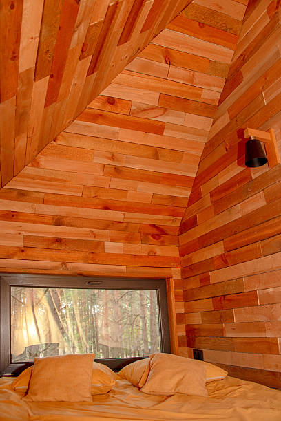 istock Cozy wooden cabin interior with a forest view through a large window. 2230301742