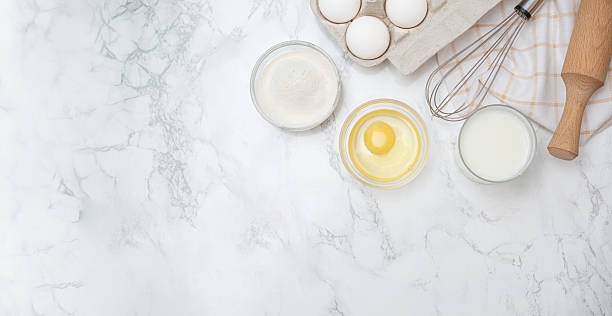 istock Baking basics with eggs, flour, and milk prepared on a marble countertop for a delicious recipe 2230301973
