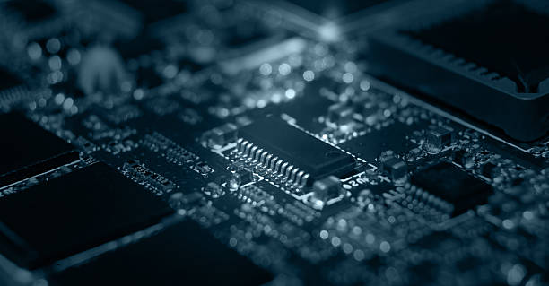 istock Close-up view of a detailed electronic circuit board with components illuminated in a dark environment 2230302013