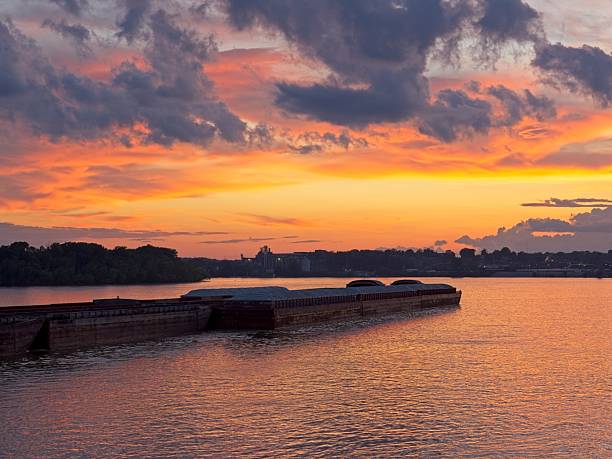 istock Barge traffic along the Ohio river in beautiful sunset light 2230302070