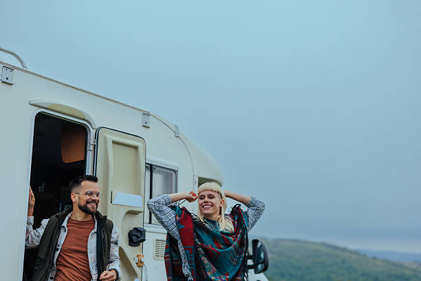 istock Two people enjoying the fresh air next to a camper van 2230303377
