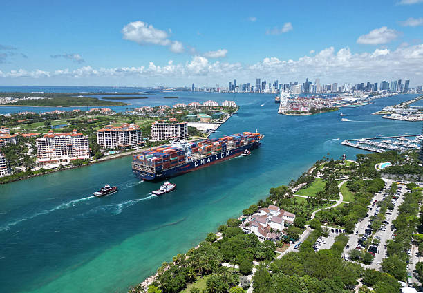 istock Miami, Florida, USA - June 07, 2024: Cargo ship in sea, aerial view. Freight container loaded on cargo vessel. Aerial view cargo ship entering port of Miami. Cargo business. Container ship. Shipping logistics. Commercial shipping. 2230304621