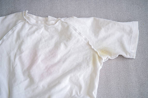 istock A yellow spot on a white T-shirt. Top view. 2230307739