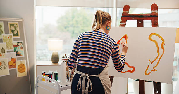 istock Back, woman and artist painting on canvas for abstract art, design process and create artwork. Female person, easel and sketch drawing, crafts technique and diy creation for creative project at house 2230309121