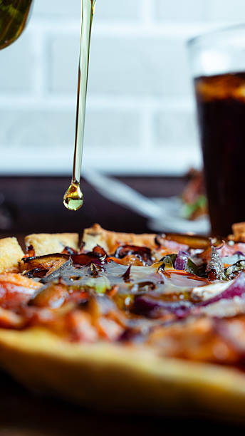 istock Olive oil pouring on delicious pizza with toppings 2230309759