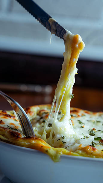 istock Serving delicious lasagna bolognese with melted cheese and herbs 2230309926