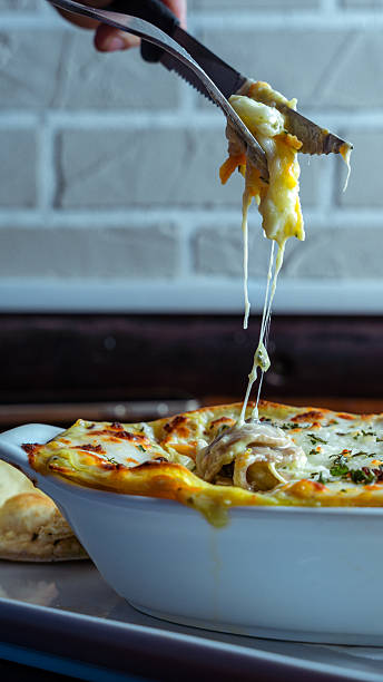 istock Fork lifting a slice of delicious lasagna with melted cheese 2230310000