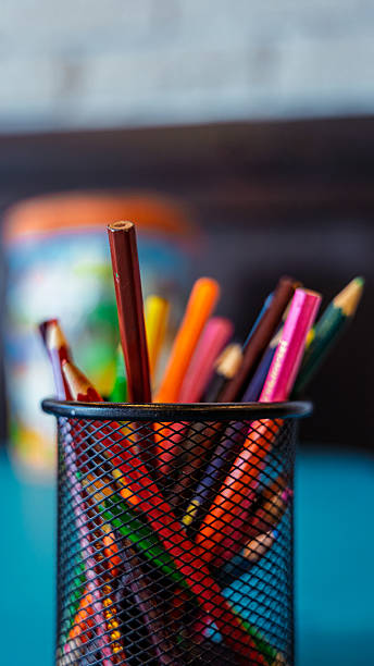 istock Colored pencils standing in a black pencil holder on a table 2230310148