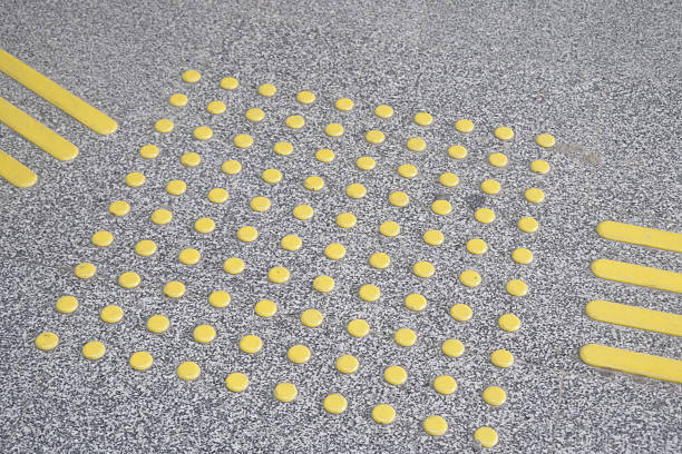 Yellow tactile paving indicators enhance ground safety for pedestrians.