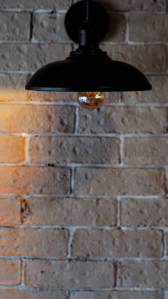 istock Vintage hanging lamp illuminating a brick wall 2230310231