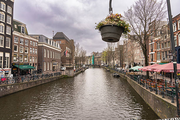 A hanging flower pot above the canal in Amsterdam