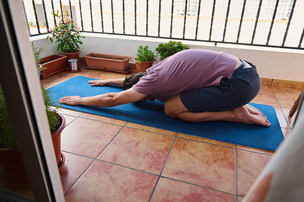 Man Practicing Yoga on Balcony in Relaxing and Serene Atmosphere