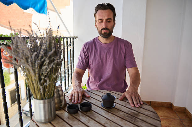istock Man Relaxing with Tea on a Balcony with Nature and Serenity 2230327438