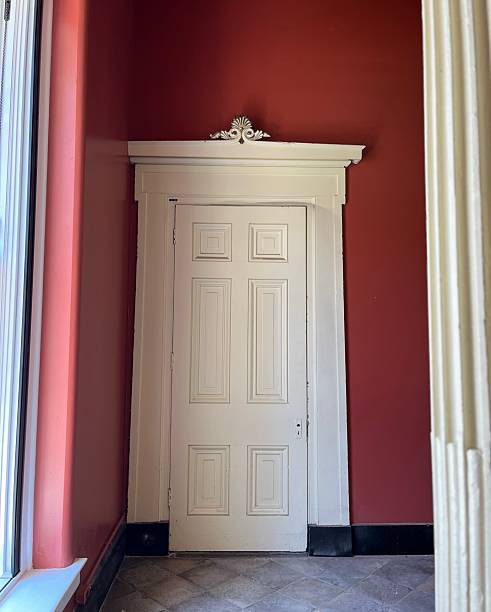 istock Old white door inside a red room 2230332167