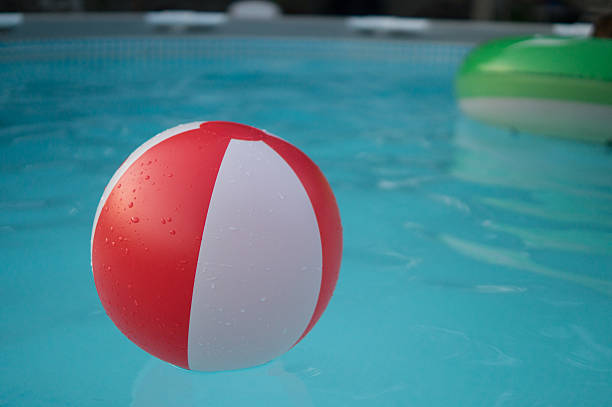 istock Red and white beach ball in a pool 2230335809
