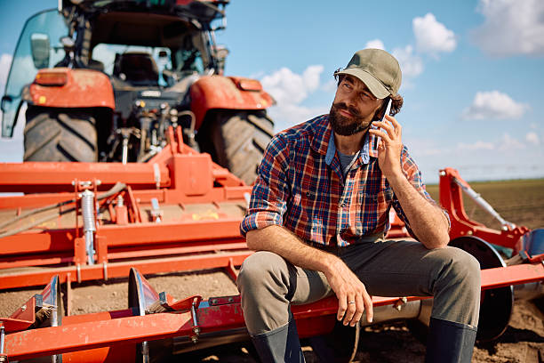 istock Farm worker talking on cell phone while relaxing during soil cultivation in the field. 2230336054