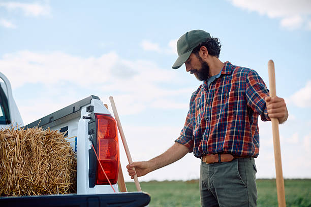 istock Farm worker using agricultural equipment while working in the field. 2230336105