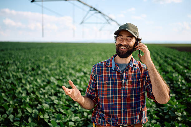 istock Happy farmer talking on smart phone in the field. 2230336135