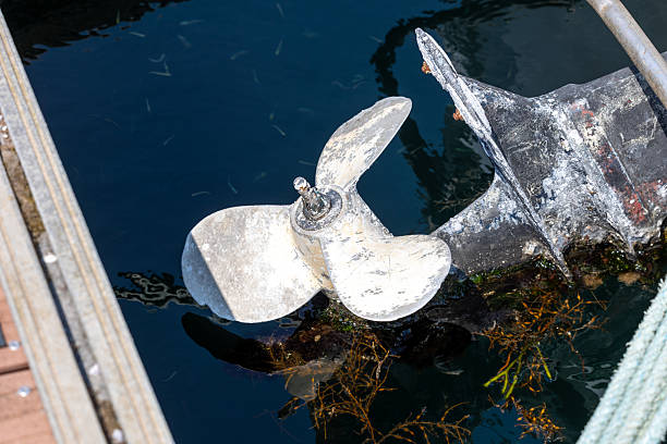 istock Outboard motor and propeller submerged in water at dock 2230340184