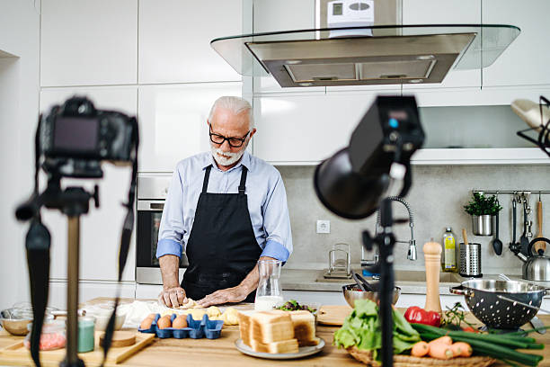 istock Senior chef recording cooking show episode in kitchen studio 2230342703