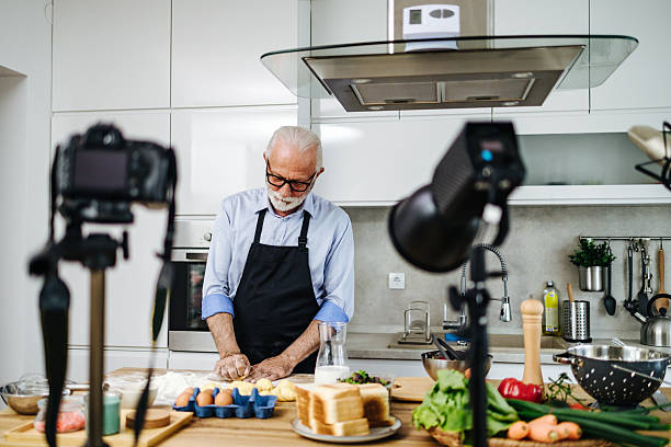 istock Senior chef recording cooking show episode in kitchen studio 2230342704