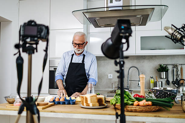 istock Senior chef recording cooking show episode in kitchen studio 2230342707