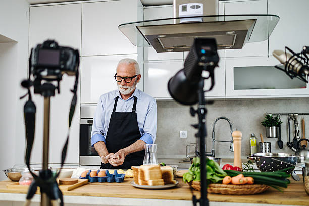 istock Senior chef recording cooking show episode in kitchen studio 2230342711