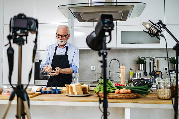 istock Senior chef recording cooking show in kitchen 2230342720