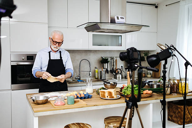 istock Senior man recording cooking show in kitchen 2230342738