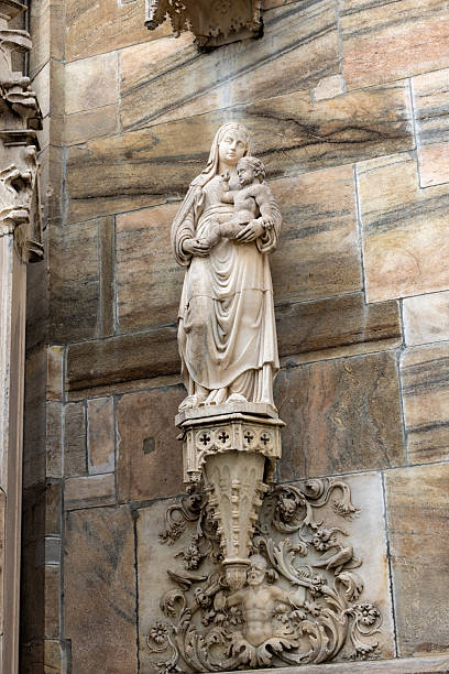 Gargoyle on the Milan Cathedral. Gothic architecture. Man, human gargoyle. Closeup of a gargoyle on the exterior facade of the Milan Duomo Cathedral in the morning.