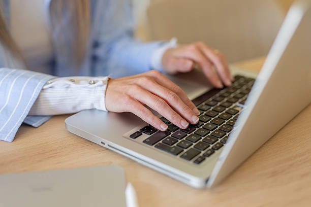 istock Close-up of hands typing on laptop keyboard in office 2230347246