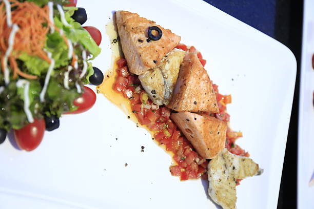 Fish with sauce served with vegetable salad