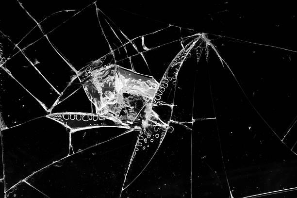 istock cracked glass isolated in black background 2230347534