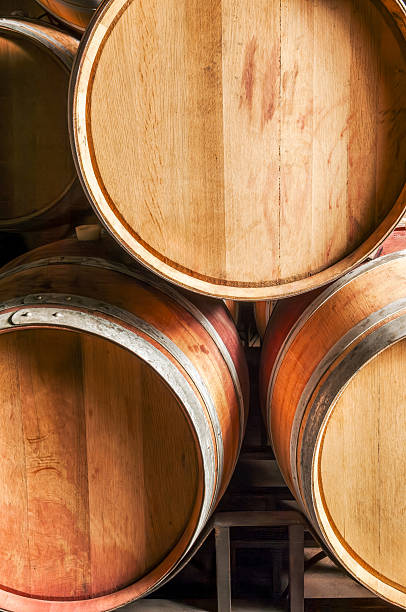 istock Close up of Wine cellar with stacked barrels 2230348173