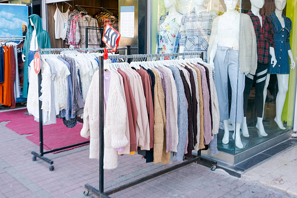 istock Rack of clothes is displayed in front of a store window 2230354387
