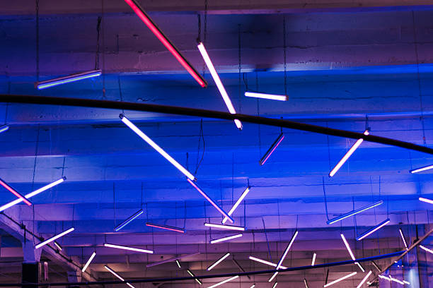 Multicolored LED lights attached to a ceiling, illuminating the venue's space and the ceiling. Abstract lights