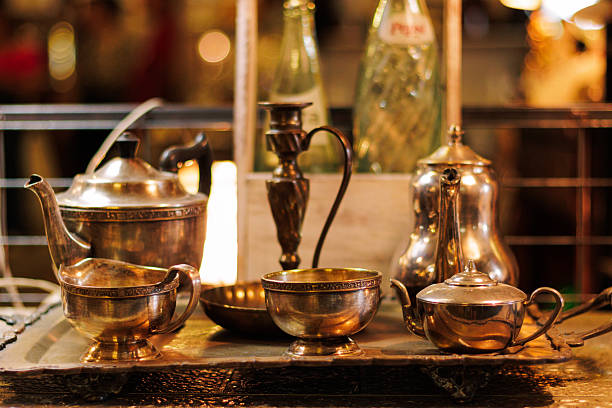 Colorful kitchen and shelf displaying antique-style dishes, plates, glasses, cups, etc., with good interior designs, very shiny and luxurious.
