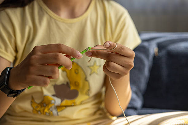 istock close up of Crocheting with a crochet hook 2230360076
