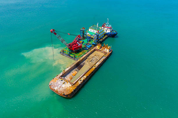 istock Aerial offshore dredging operation with crane barge 2230364416