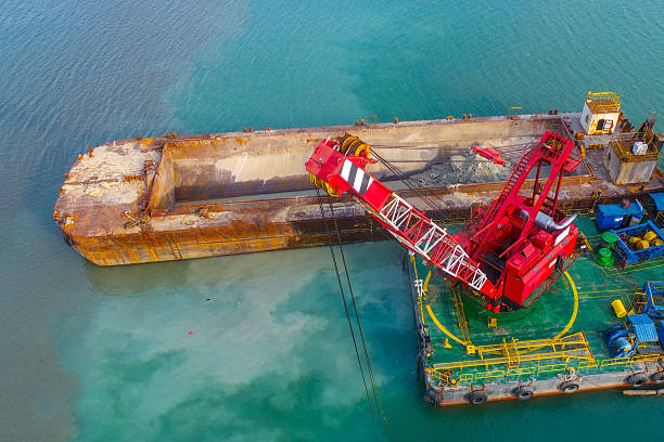 istock Industrial dredger crane working at harbor 2230364418