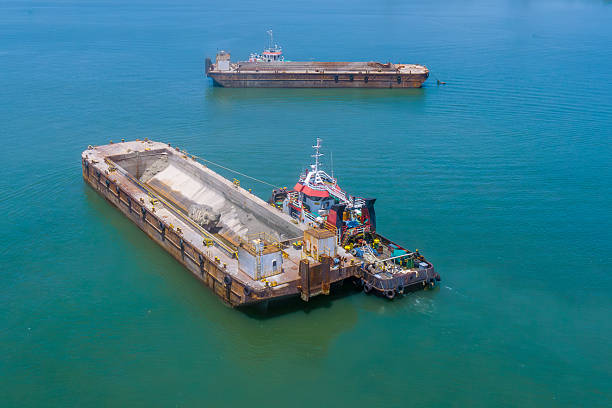istock Marine tug assisting dredging barge on water 2230364480