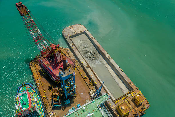 istock Offshore barge with crane and rocks for port and reclamation works 2230364566