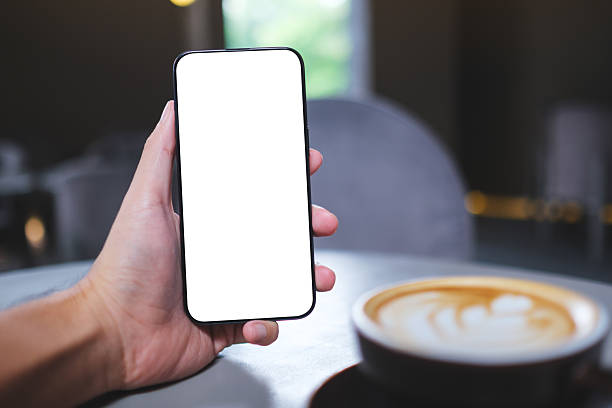 istock Mockup image of a man holding mobile phone with blank white screen in cafe 2230369795