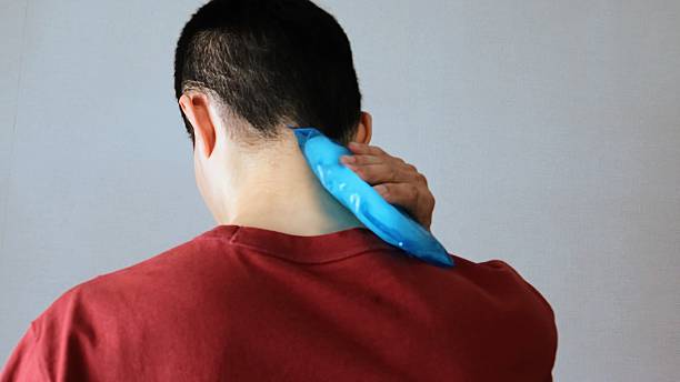Close-up of a person's back cooling down with an ice pack