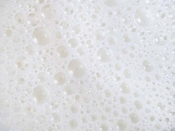 istock Close up macro photography of white foam bubbles on a liquid surface 2230377779